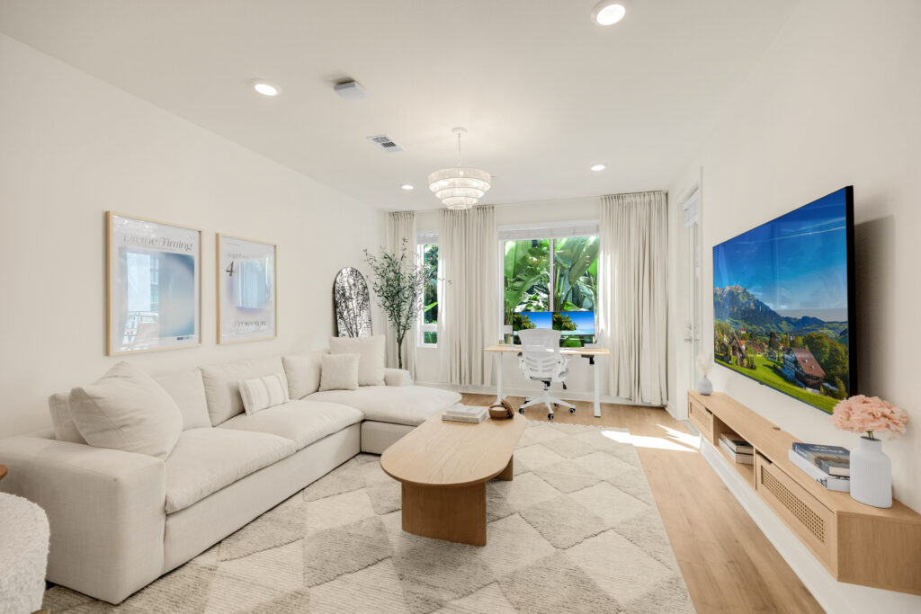 living area with sofa and HD display TV
