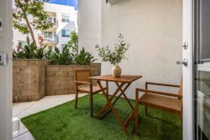 balcony view with wooden chair & table.